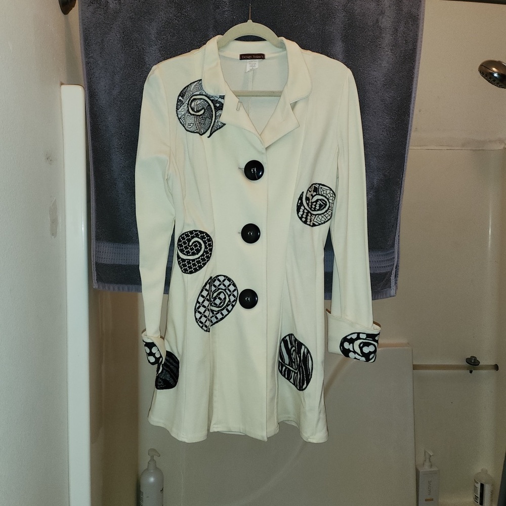 Chic White Coat with Black Patterned Accents